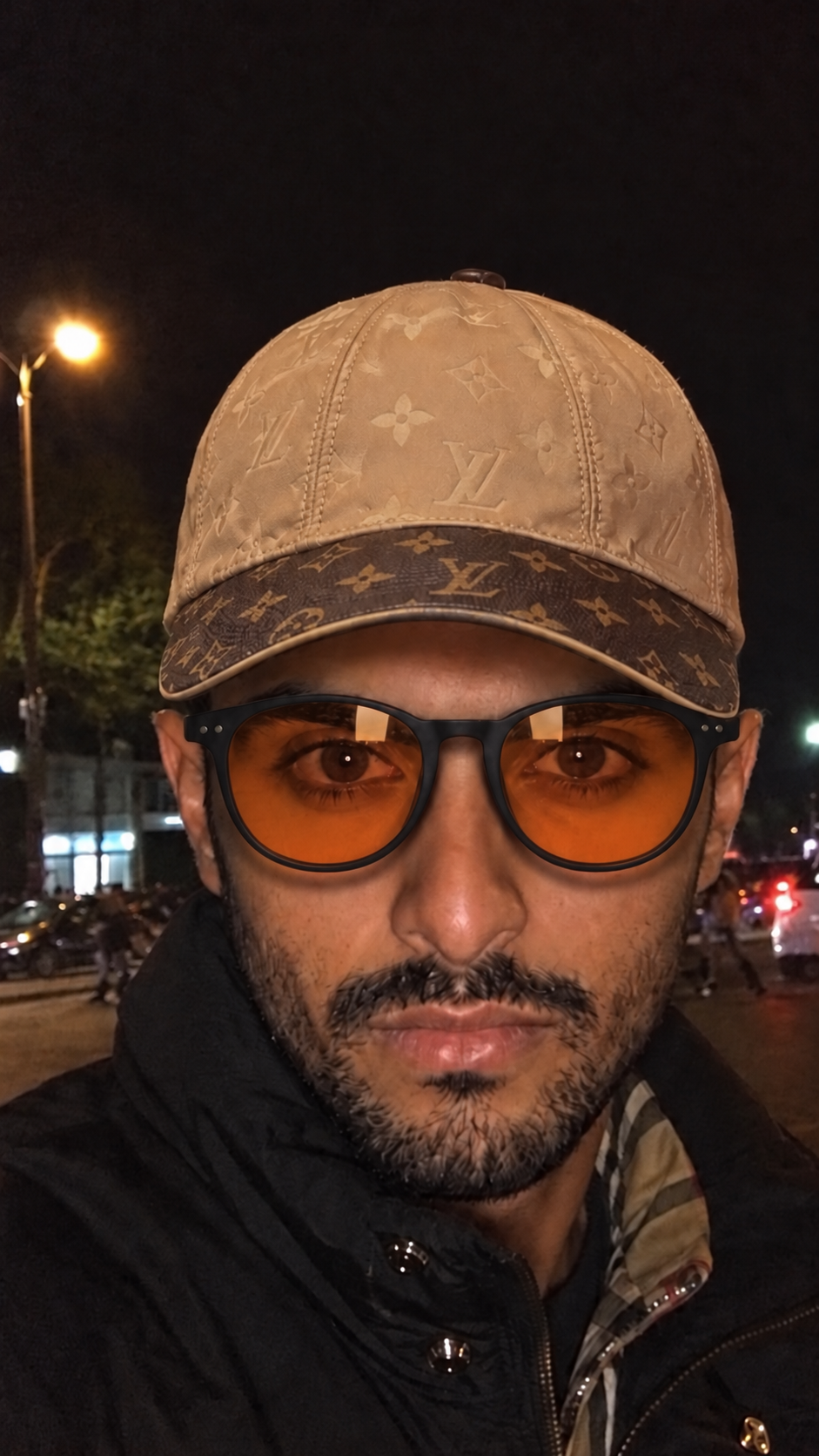 Dr. Rayan Marzuqi in Jeddah, wearing a tan cap and amber glasses